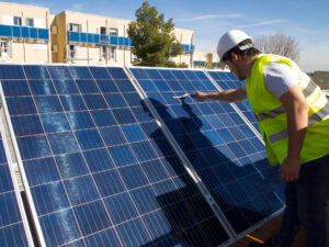 worker inspecting solar panels