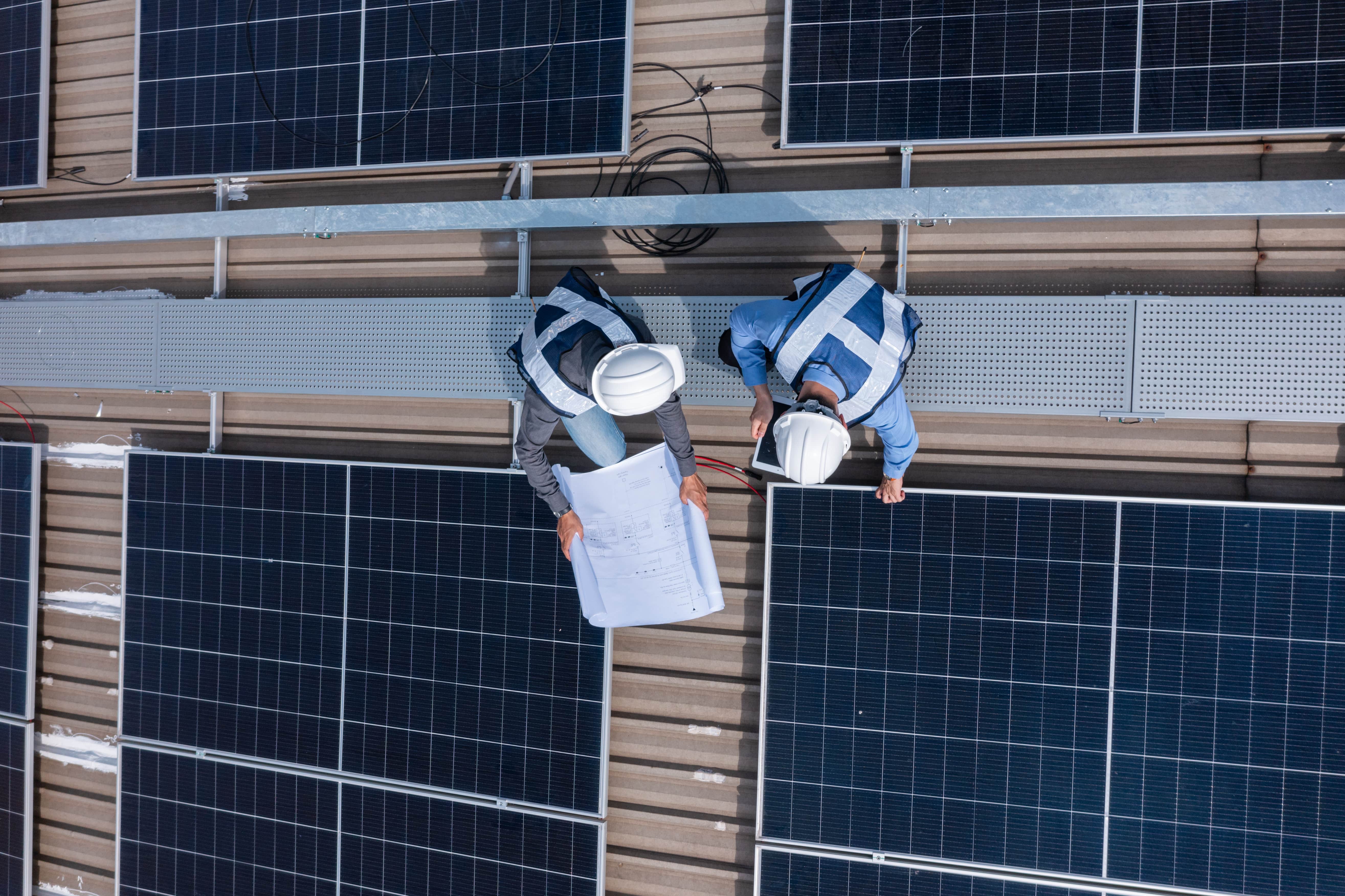 professional workers installing solar panels