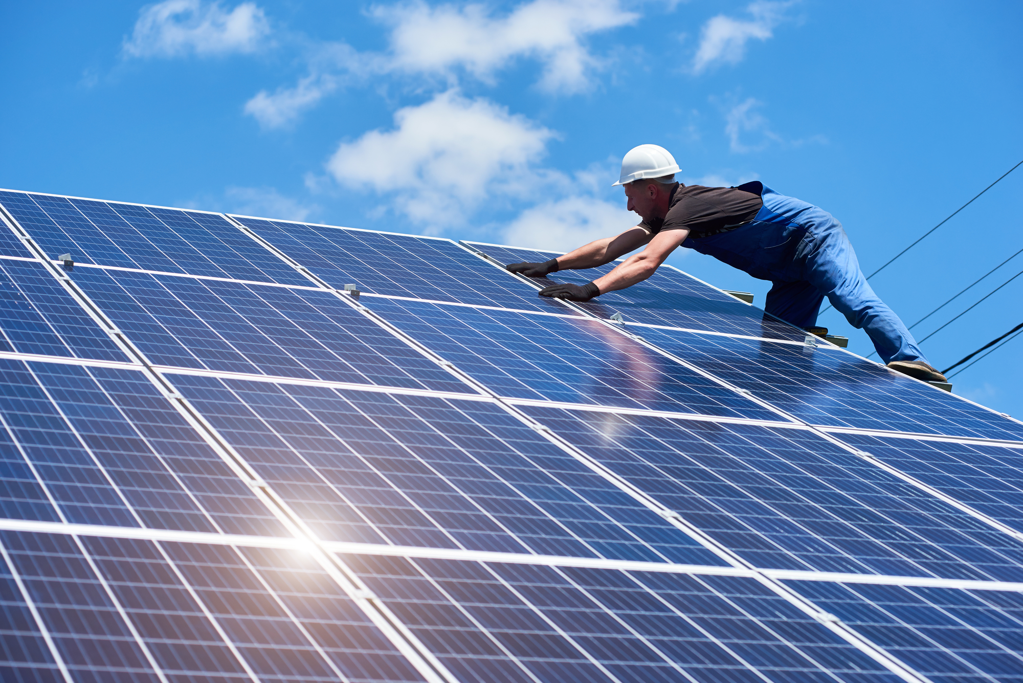 Professional worker installing solar panels