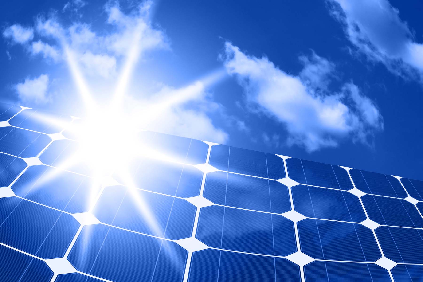 skilled workers installing solar panels on roof of house